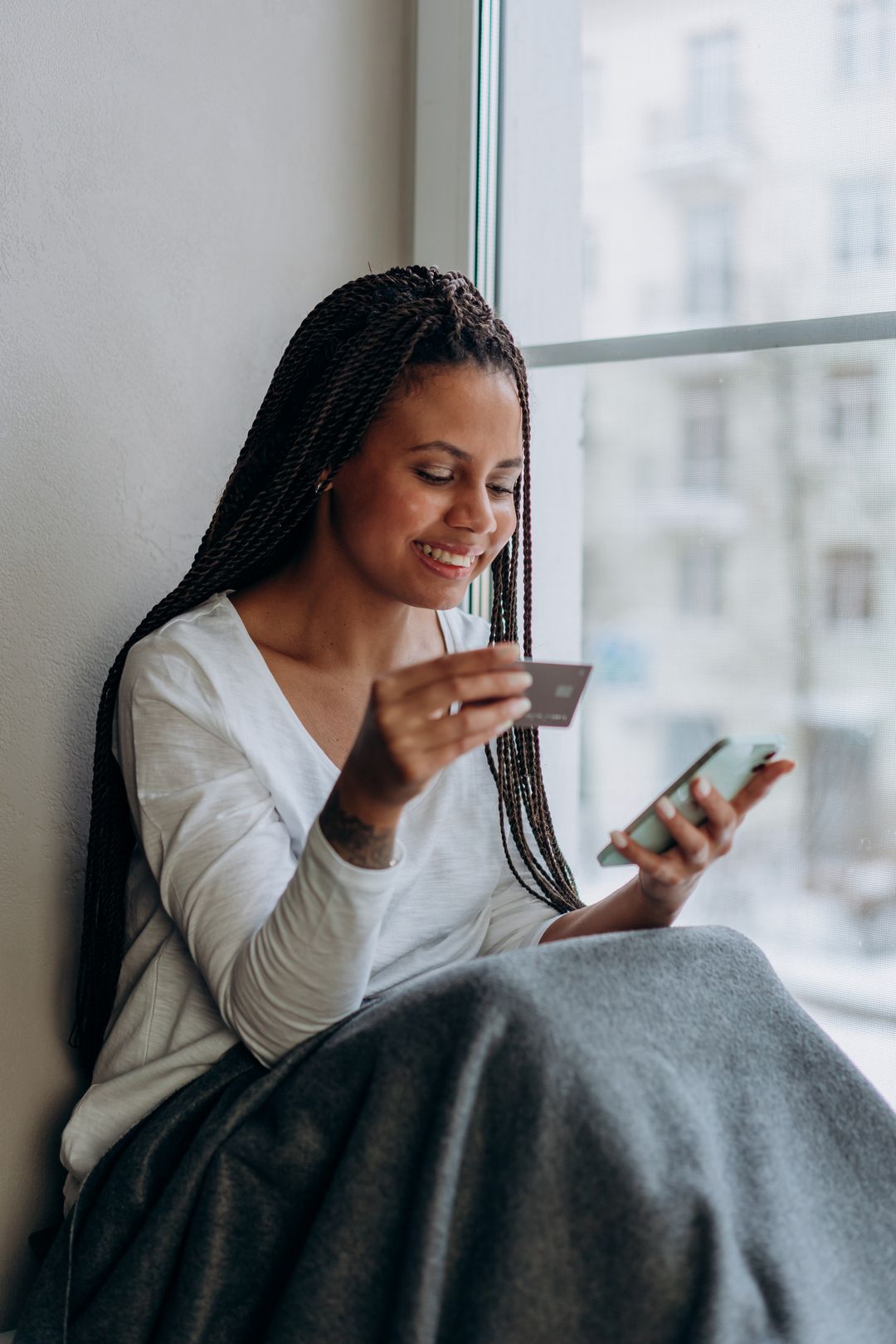 A woman sending money on her phone